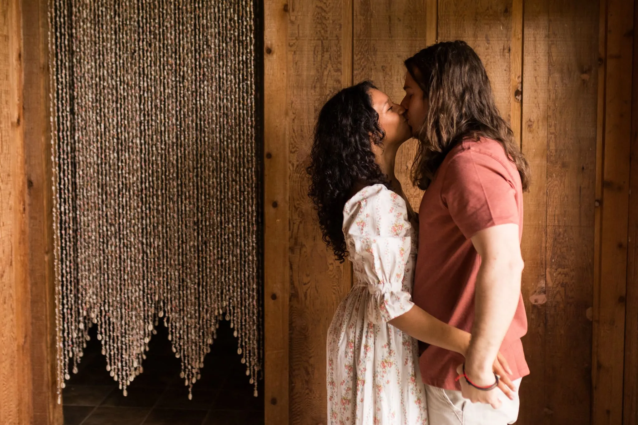 Adam and Destiny kissing for their wedding engagement session set at their home